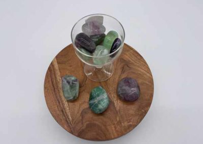 Assorted healing crystals in a cup